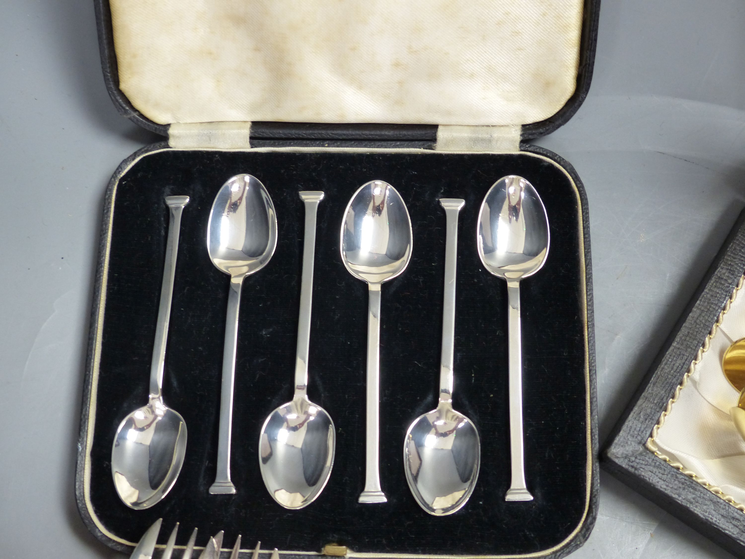 A set of twelve Christofle forks, a cased set of English coffee spoons and a set of Solingen gold-plated spoons.